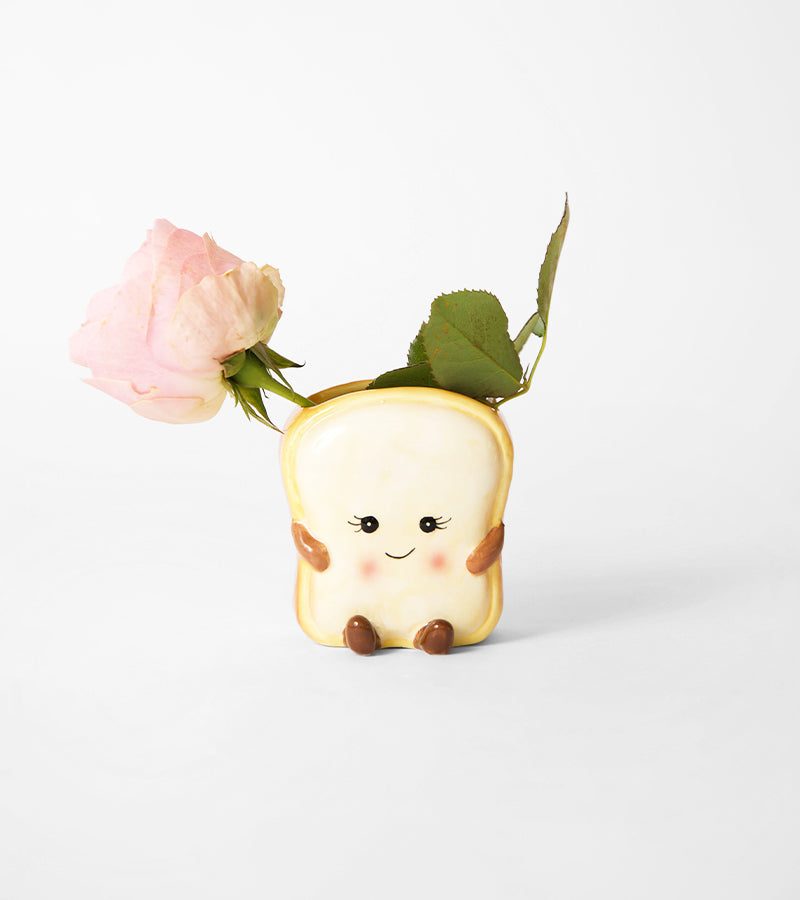 Mini cache-pot en céramique en forme de toast souriant avec une fleur rose