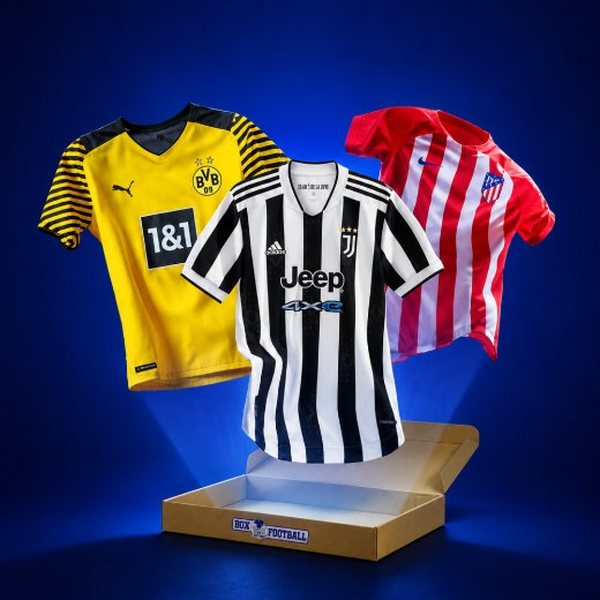 Trois maillots de football officiels présentés devant une box sur fond bleu
