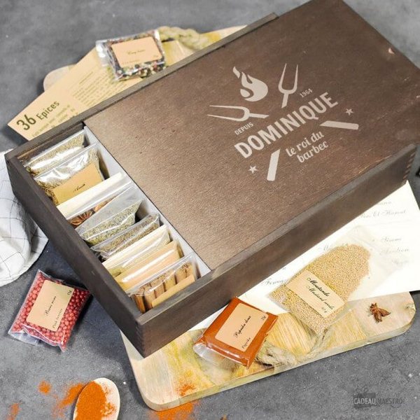 Coffret en bois gravé « Dominique » ouvert sur 36 sachets d'épices pour barbecue